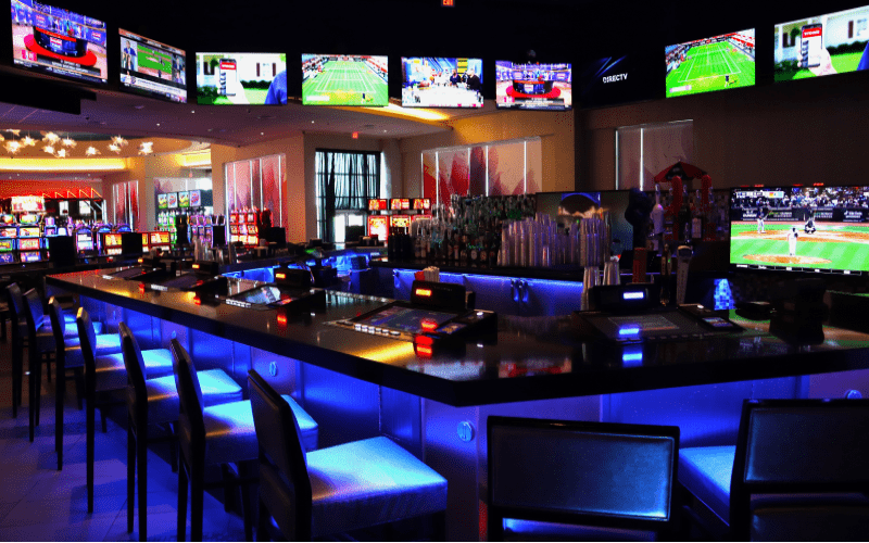 sportsbar with tvs all around and casino floor in back